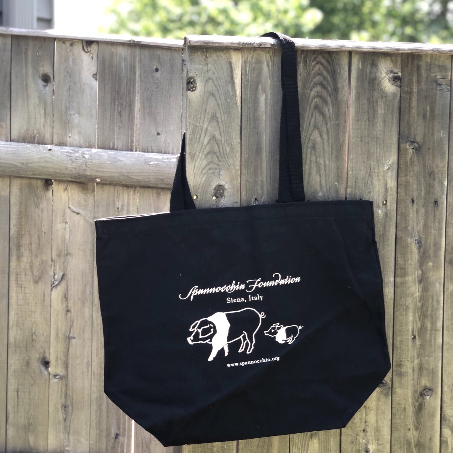 Black Spannocchia Foundation tote hanging on fence