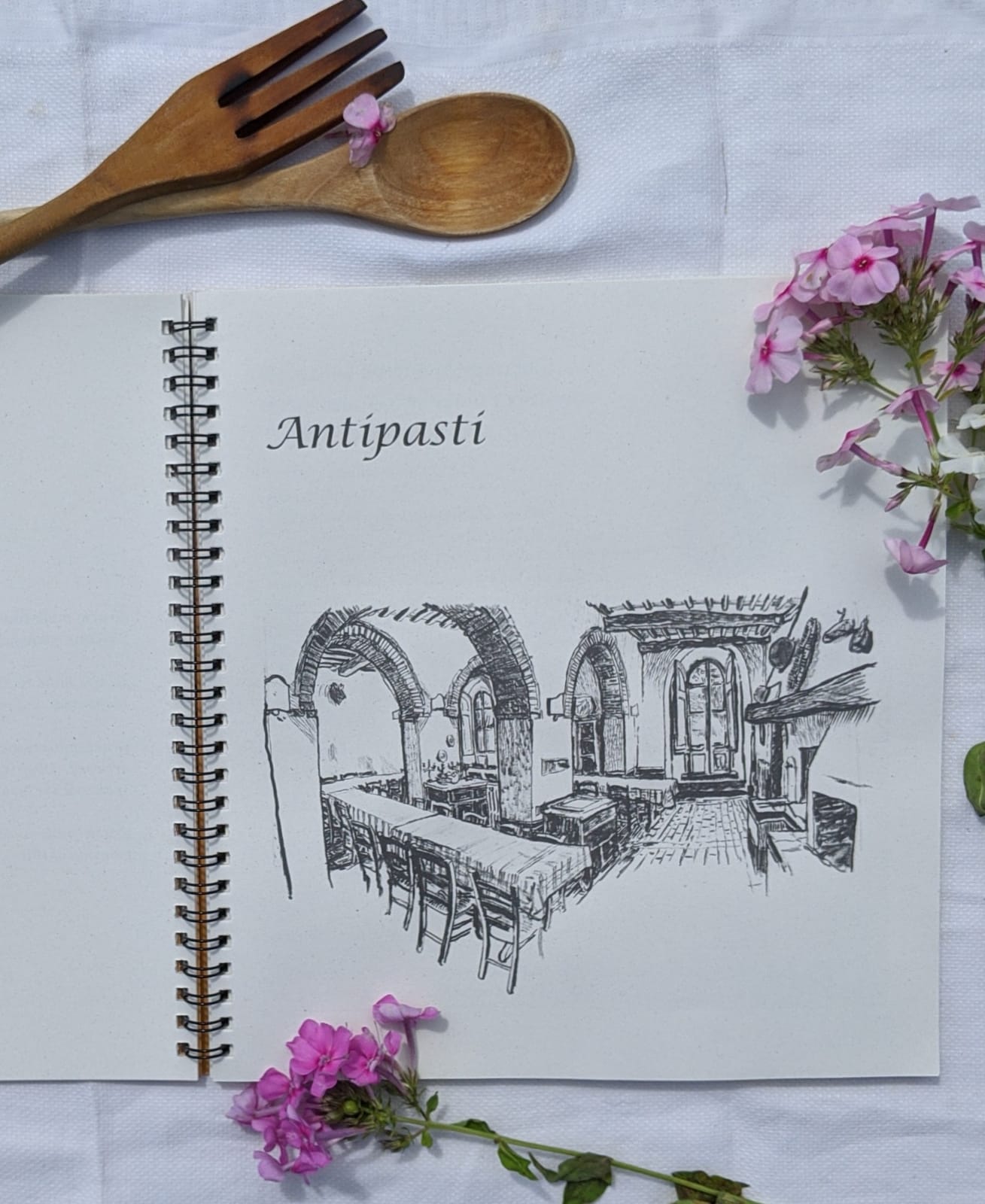 Open book showing the "Antipasti" page